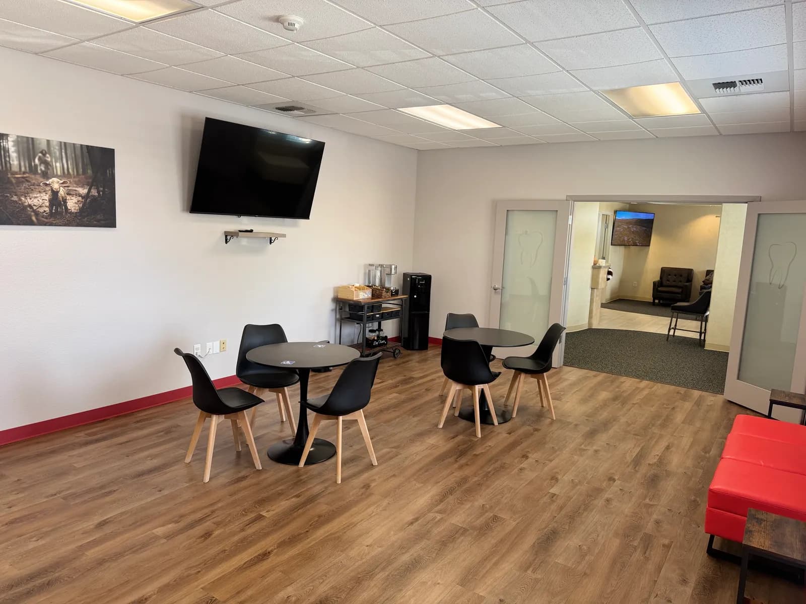 Patient lounge at Navarro Dentistry with café-style tables and chairs