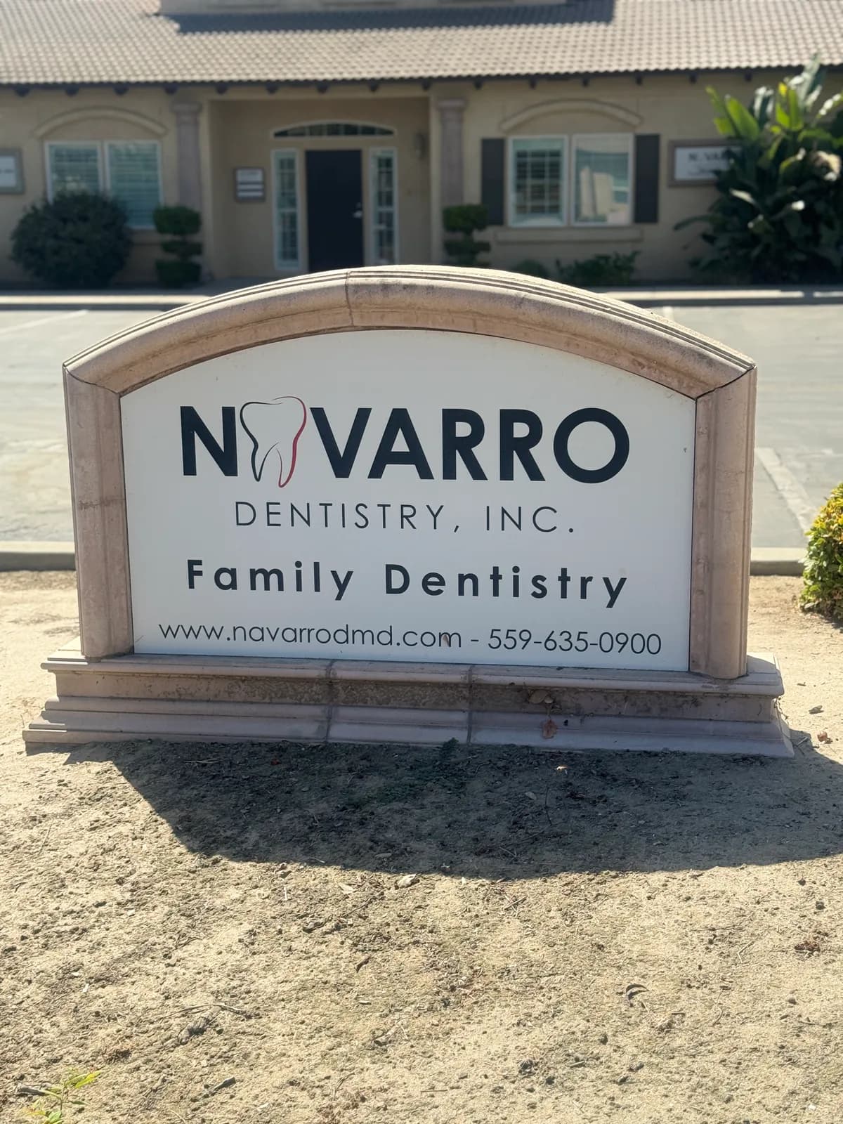 Monument sign reading Navarro Dentistry, Inc. Family Dentistry outside the Visalia office