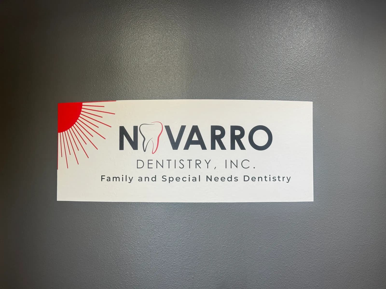 Wall banner reading Navarro Dentistry, Inc. Family and Special Needs Dentistry